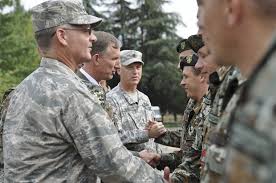 U.S. Air Force Maj. Gen. Steven Cray, the adjutant general of the Vermont National Guard, pins a medal on one of 79 soldiers from the army of Macedonia